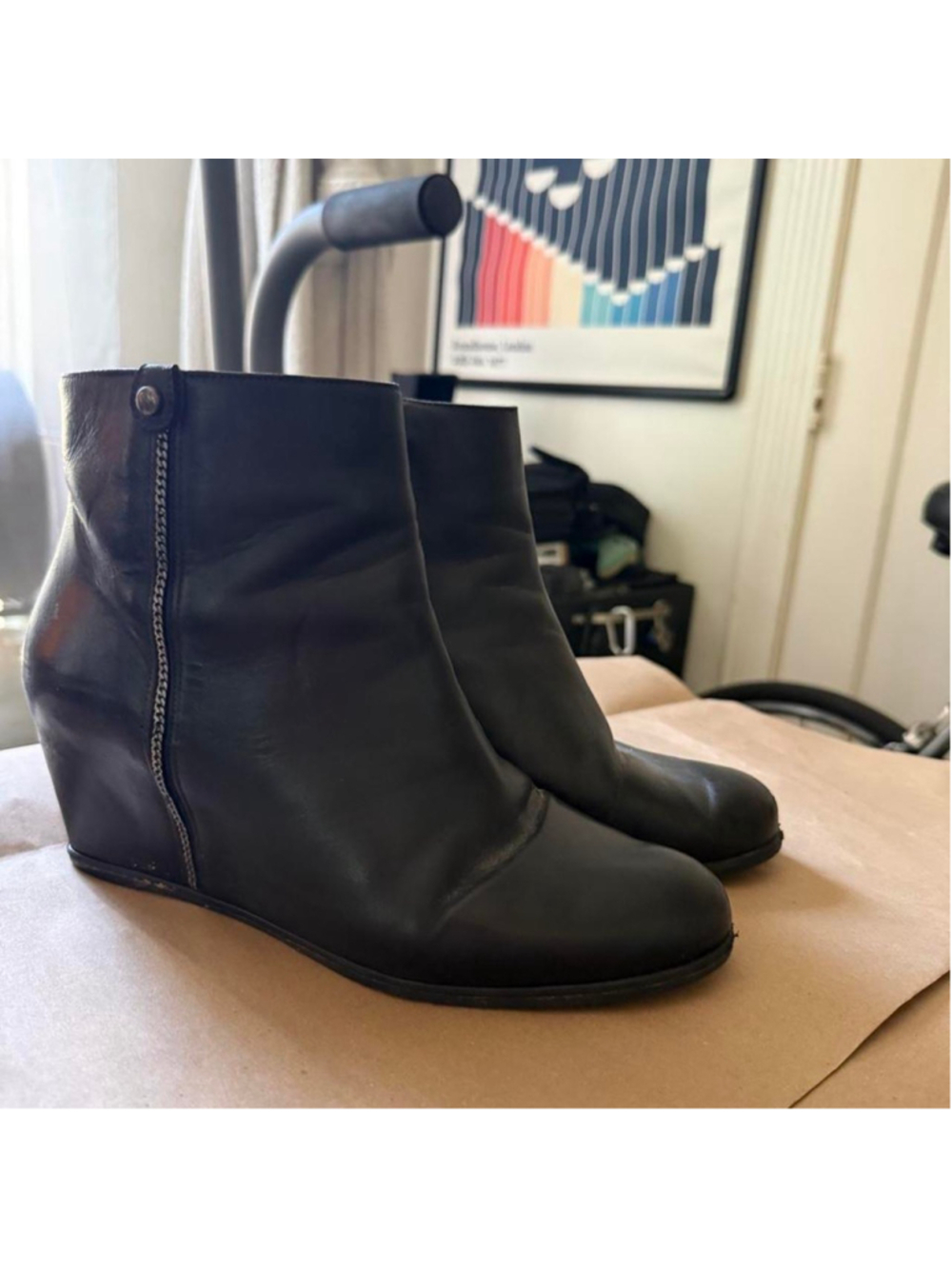Stuart Weitzman black leather ankle booties featuring a sleek hidden wedge heel